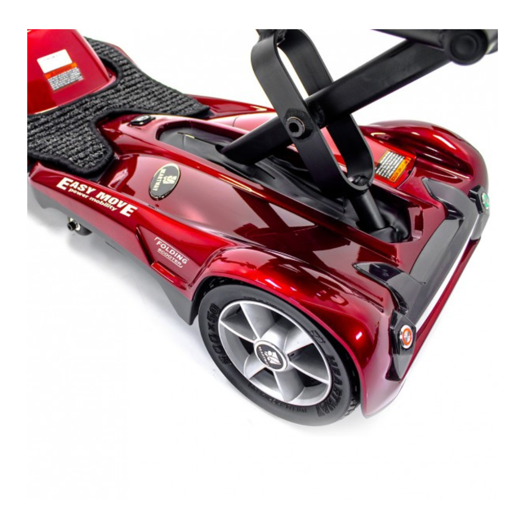 Close-up of the rear section of a shiny red EV Rider TranSport S19AF Automatic Folding Travel Scooter, showing the wheel, platform, and folded black seat support.