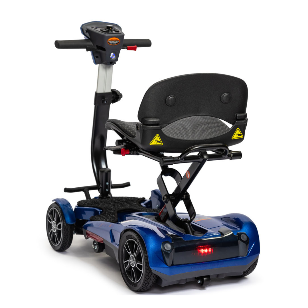 The EV Rider Transport 4M Travel Scooter is a blue, four-wheel lightweight scooter with a padded seat and backrest plus a handlebar for steering, shown from the rear.