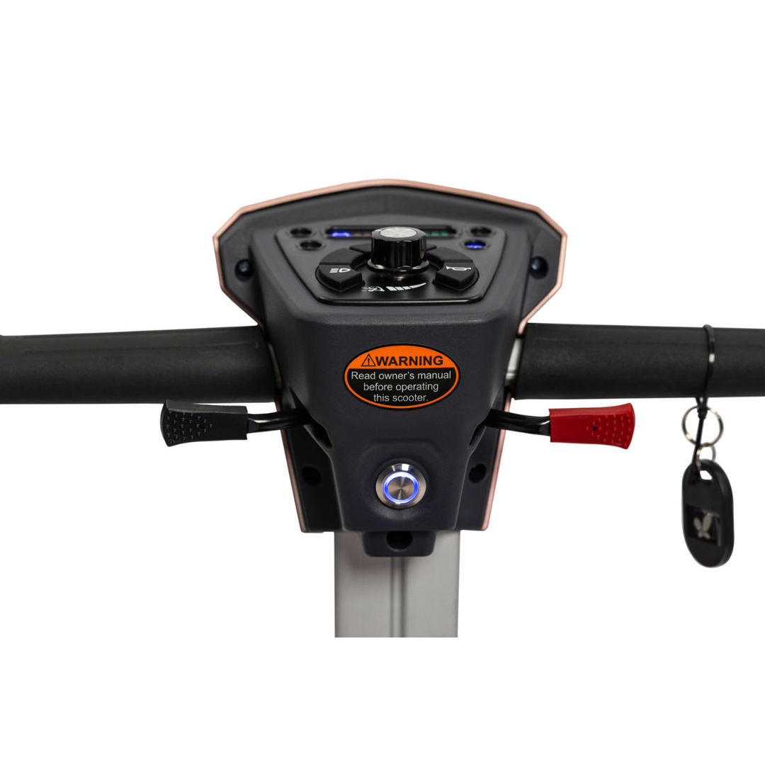 Close-up of the EV Rider Transport 4M Travel Scooter dashboard showing control buttons, a dial, warning label, handlebars with red and black levers, and an ignition with a key inserted on the right side.