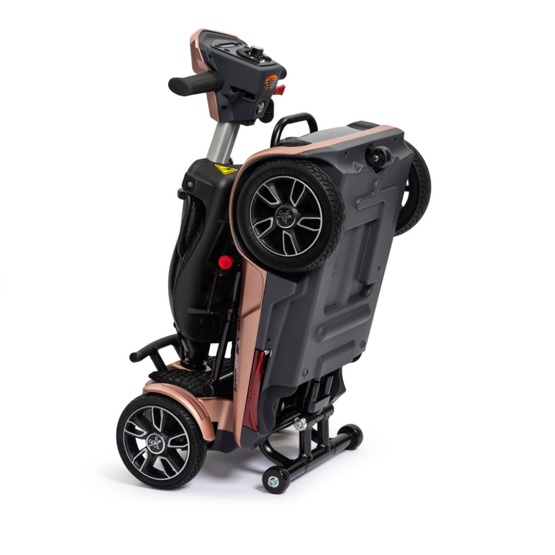 The EV Rider Transport 4M Travel Scooter is compact, airline-approved, and stands upright on its rear wheels, showcasing a foldable design and an intuitive control panel—ideal for travel and easy portability.