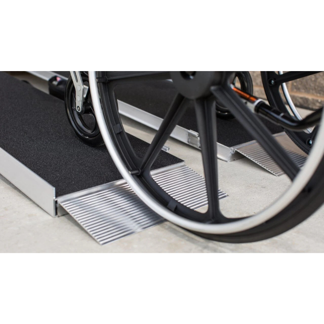 Close-up of a wheelchair wheel on the EZ-Access SUITCASE® Singlefold AS Portable Ramp, featuring a slip-resistant surface to help the wheelchair safely cross steps or elevated surfaces.