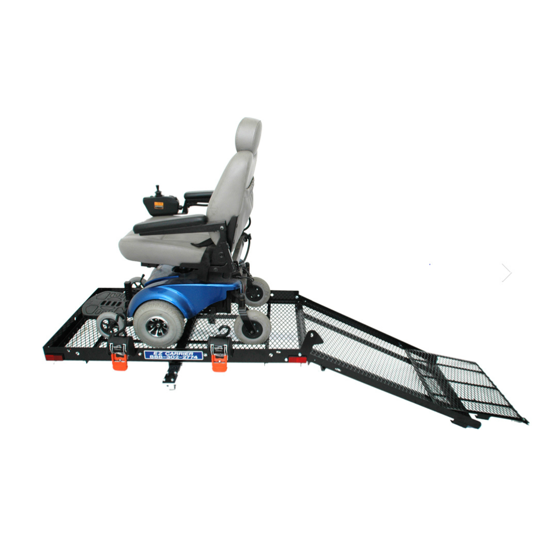 An EZ-Carrier Manual Fold Up Vehicle Mobility Carrier holds a blue electric wheelchair on its black metal platform, with the mesh ramp extended for easy vehicle entry or transport.