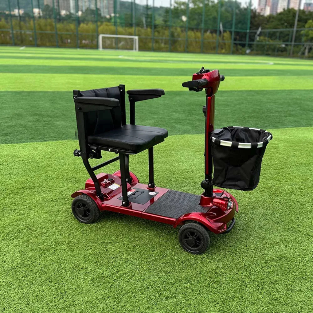 An Easwe™ M10 Portable Long Range Mobility Scooter in red with a black seat, armrests, and front basket is parked on green turf near a soccer goal and trees. The scooter offers a 30-mile range for extended outings.