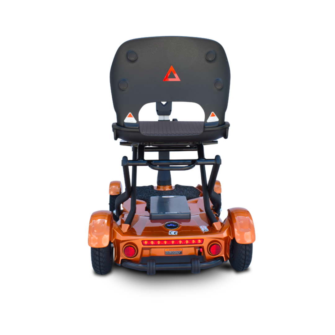 The EV Rider Teqno Automatic Folding Portable Travel Scooter is shown from the rear, featuring an orange body, black seat with armrests, red safety triangle, and visible rear lights, set against a white background.
