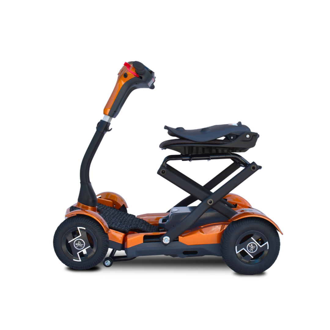 The EV Rider Teqno Automatic Folding Portable Travel Scooter is a compact, orange three-wheel scooter with a raised foldable seat and black handlebar, shown from the side against a white background.
