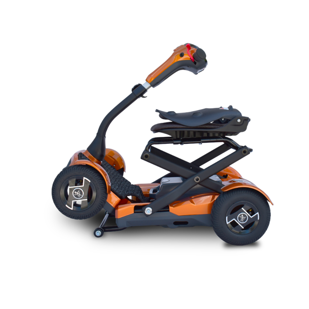 The EV Rider Teqno Automatic Folding Portable Travel Scooter is a modern, compact orange mobility scooter with a folding frame and black seat, shown in side profile against a white background.