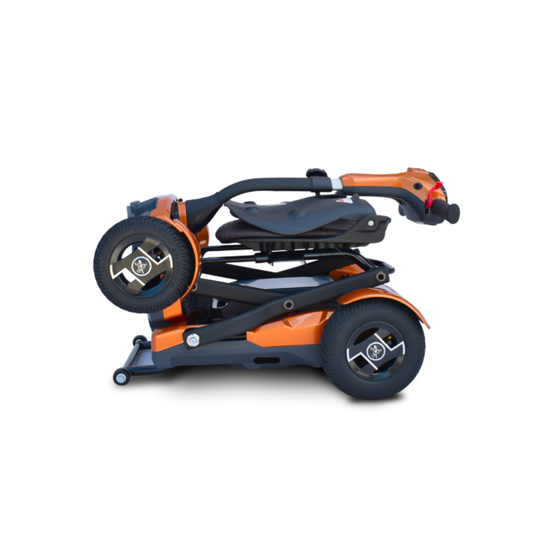 The EV Rider Teqno Automatic Folding Portable Travel Scooter, in compact orange, is folded for transport with its black wheels, seat, and handlebars neatly stacked to ensure easy portability.