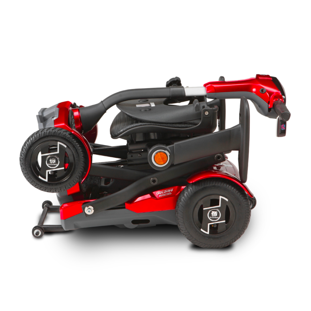 The EV Rider Teqno Automatic Folding Portable Travel Scooter in red is shown folded for transport, with its black wheels and seat neatly tucked into the frame, set against a white background.