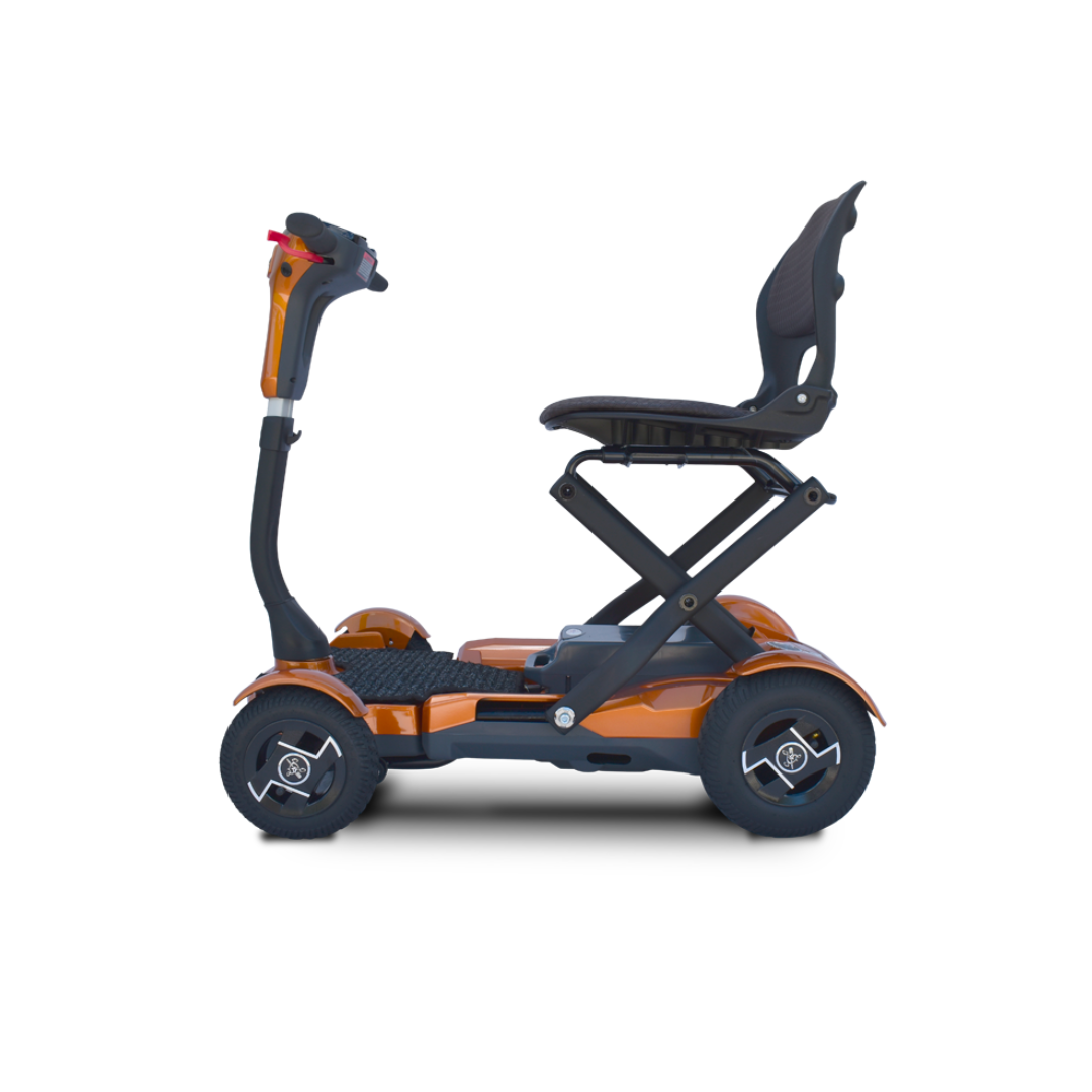The EV Rider Teqno Automatic Folding Portable Travel Scooter is a compact, orange scooter with a black seat and four wheels, displayed in profile on a white background.