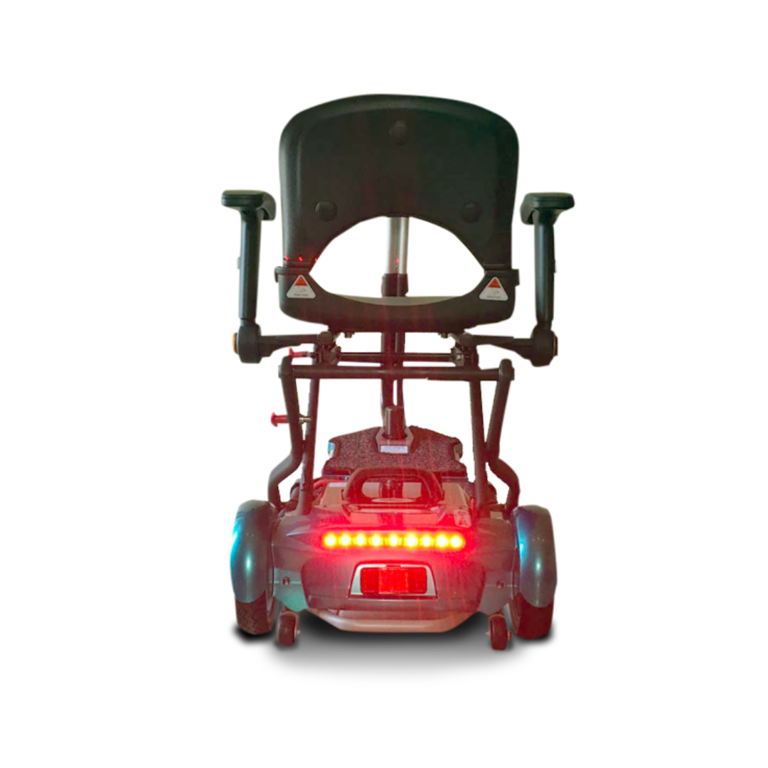 Rear view of the EV Rider Transport Plus Portable Mobility Scooter with armrests, black seat, and red rear lights on a white background—perfect for travel thanks to its foldable, portable design.