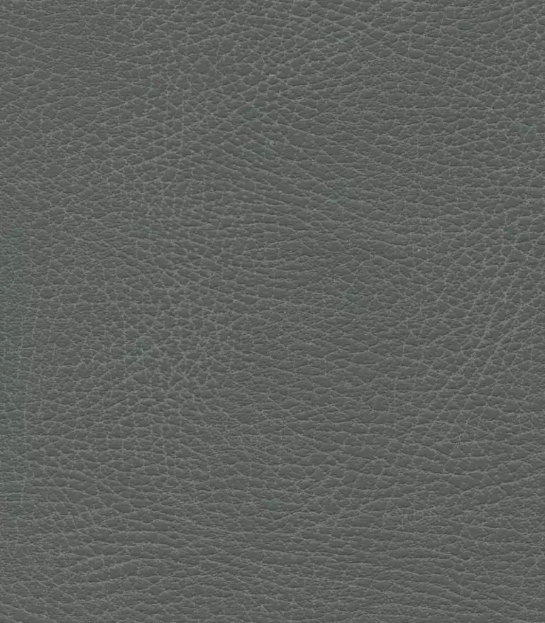 Close-up of a dark green leather texture with visible grain and creases resembles the intricate pattern on a PR766 Relaxer MaxiComfort Recliner With Lift Assist. The material looks soft and well-worn, with a slight sheen highlighting its luxurious depth.
