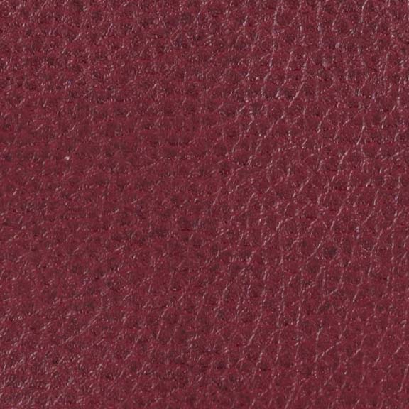 Close-up texture of red leather with fine grain patterns and a slightly glossy finish, ideal for the Golden Tech PR766 Relaxer MaxiComfort Recliner With Lift Assist - Small, blending style with modern comfort.