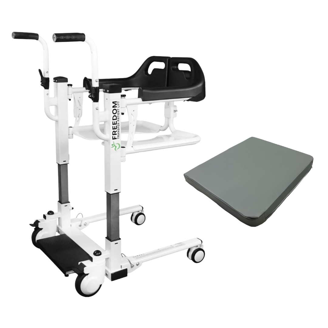 The Freedom Electric Mobile Transfer Patient Lift - Open Box Slightly Used is a white portable lift with black handles, seat, footrests, caster wheels, and “FREEDOM” on the side. Shown with a gray rectangular cushion for patient mobility assistance.