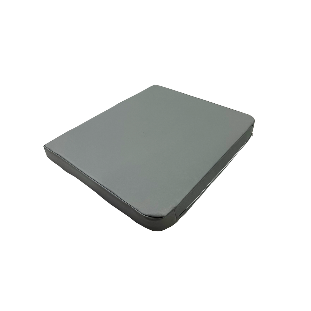 The Freedom Seat Cushion for FCOM Patient Lifts is a square, gray cushion with smooth upholstery, shown on a white background—ideal for use with patient lifts.