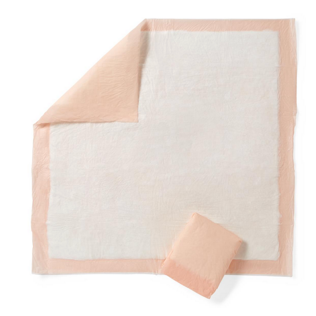 A large, square Medline FitRight Underpad with a peach border and white center is shown flat with one corner folded back, next to a matching folded pad. Known for high absorbency and disposable convenience.