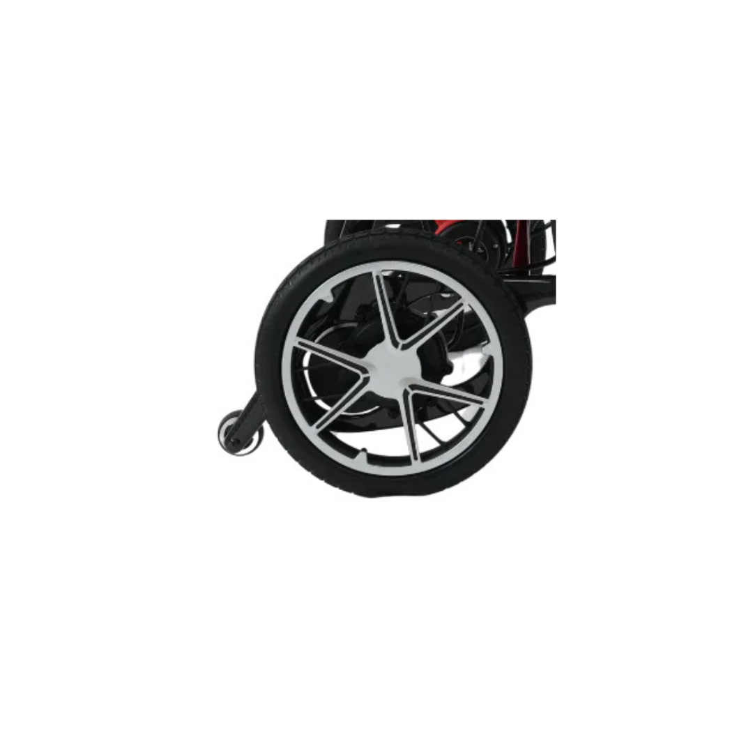 Close-up of a wheelchair wheel with a black tire, silver spokes, and a smaller caster wheel—perfect as Replacement Parts For Forcemech G10 Powerchair—shown on a white surface.
