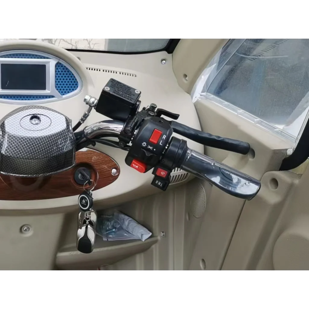Close-up of the handlebar and control panel inside a GIO Golf Fully Enclosed Mobility Scooter with Heater and Cooling Fan, showing the throttle, switches, key in the ignition, and dashboard display screen.