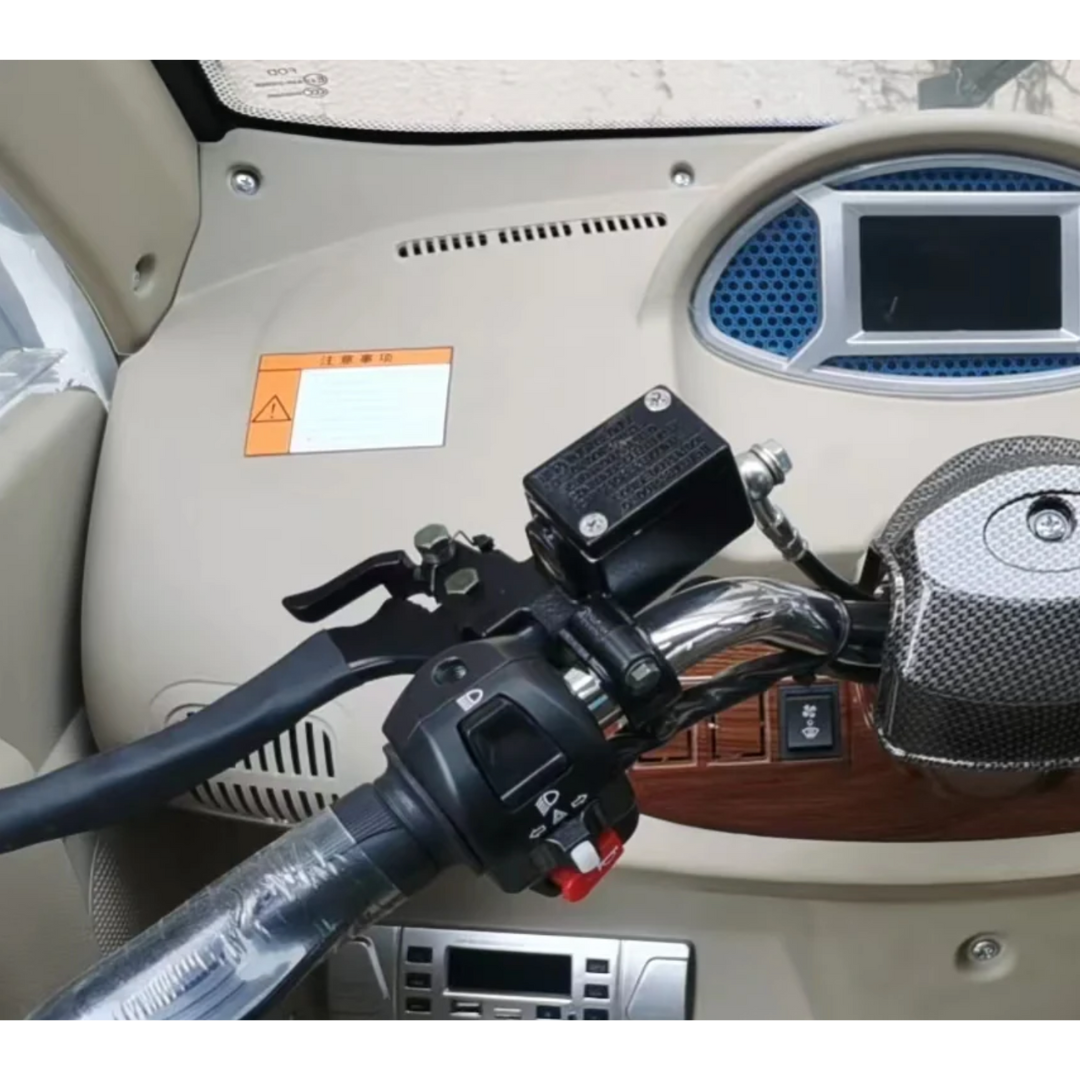 Close-up of the GIO Golf Fully Enclosed Mobility Scooters dashboard showing a steering handle with controls and display screen. Beige wood-like trim, buttons, and a foreign label contribute to its luxurious feel.