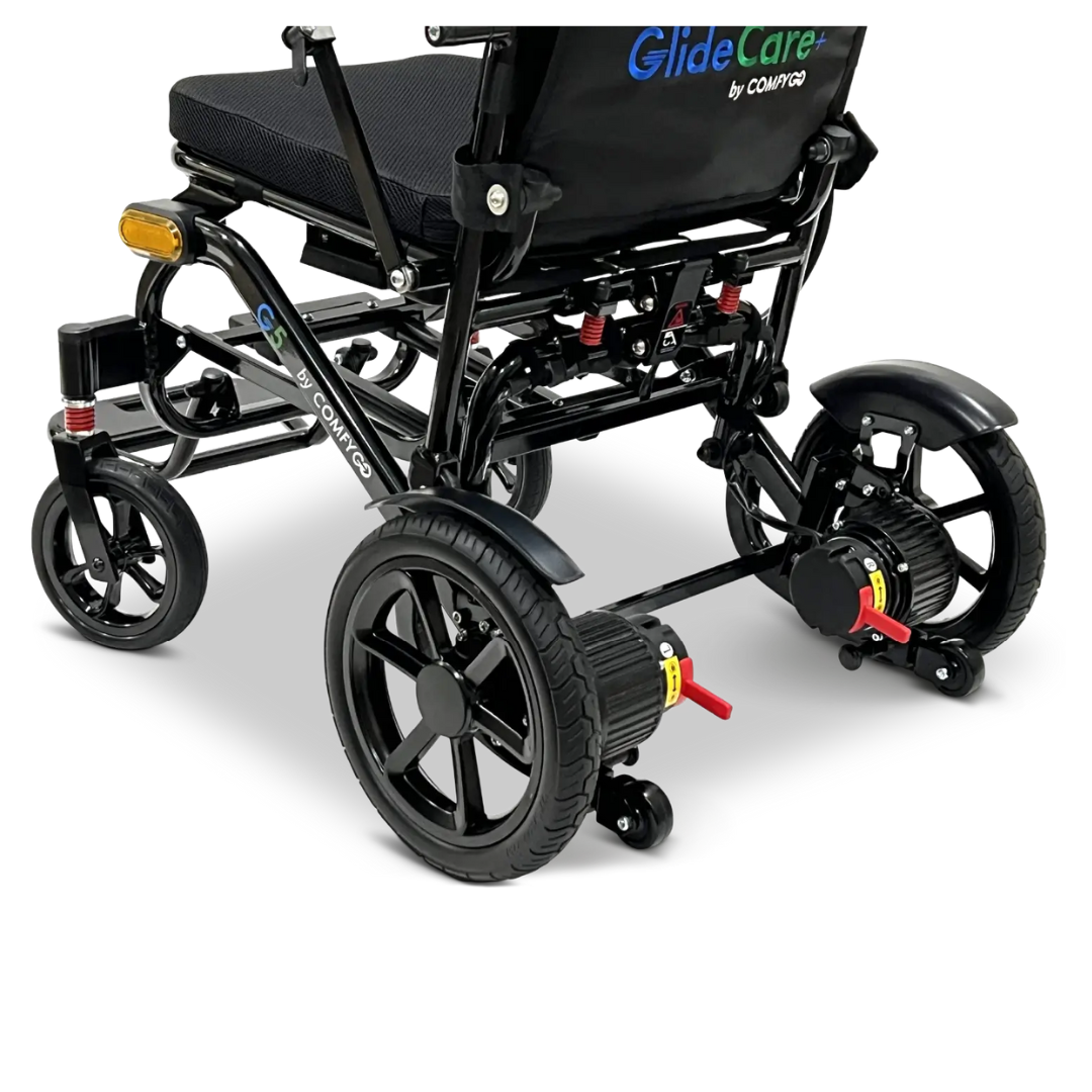 A close-up of the rear wheels and lower frame of the Glide Care G-5 PRO Lightweight Foldable Electric Wheelchair shows its dual motors and suspension—perfect for travelers seeking a reliable mobility solution.