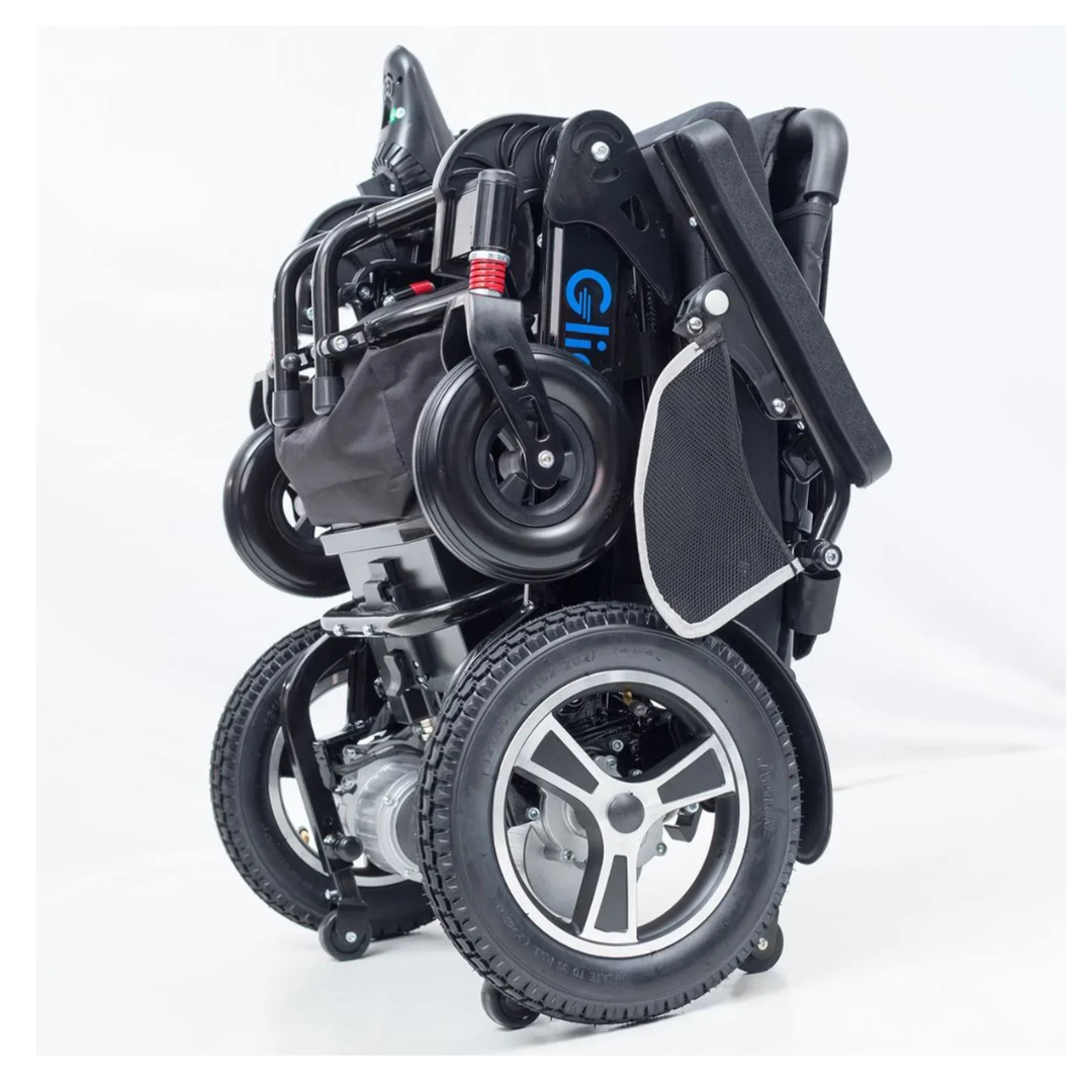The Glide Care G-6 Lightweight Foldable Electric Wheelchair stands upright in its compact, folded form, featuring large rear wheels, small front wheels, and a tucked footrest against a plain white background.