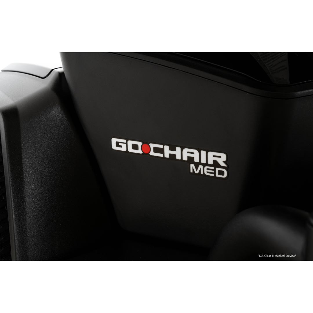 Close-up of a black Pride Mobility Go Chair® MED Portable Powerchair with “GO CHAIR MED” in white and red letters on its side.