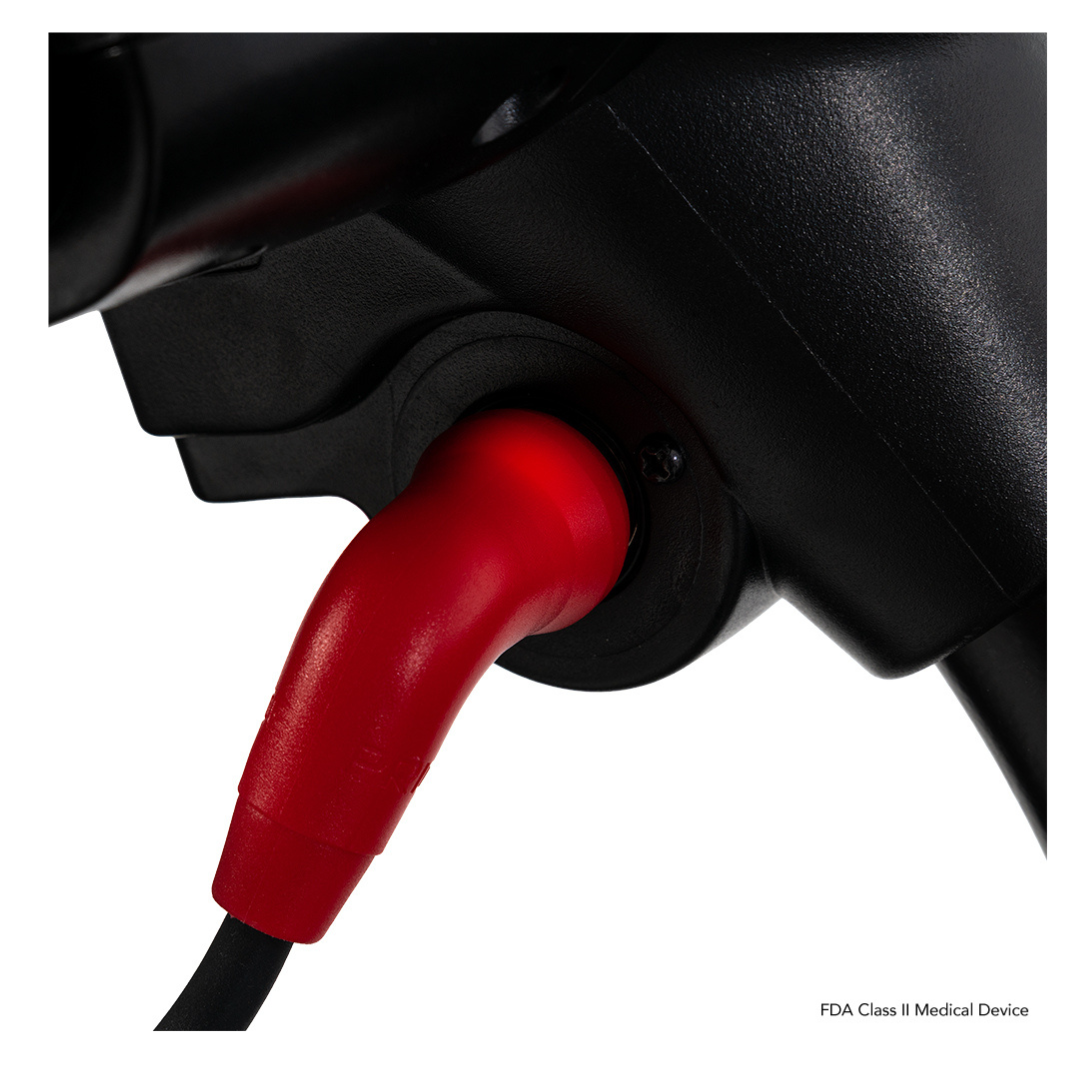 A red cable is securely plugged into a Pride Mobility Go Go Elite Traveller® 2 Platinum Scooter with EZ Turn technology. FDA Class II Medical Device text appears in the bottom right corner.