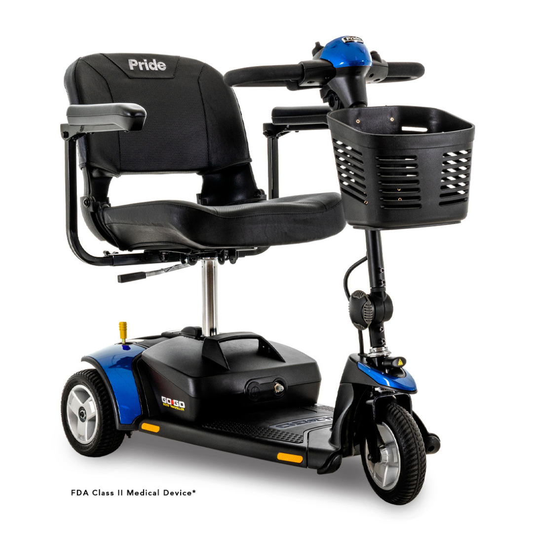 The Pride Mobility Go Go® Elite Traveller 3-Wheel Mobility Scooter is blue and black with a padded seat, backrest, front basket, lightweight design, and sturdy build. It supports mobility and allows style customization.