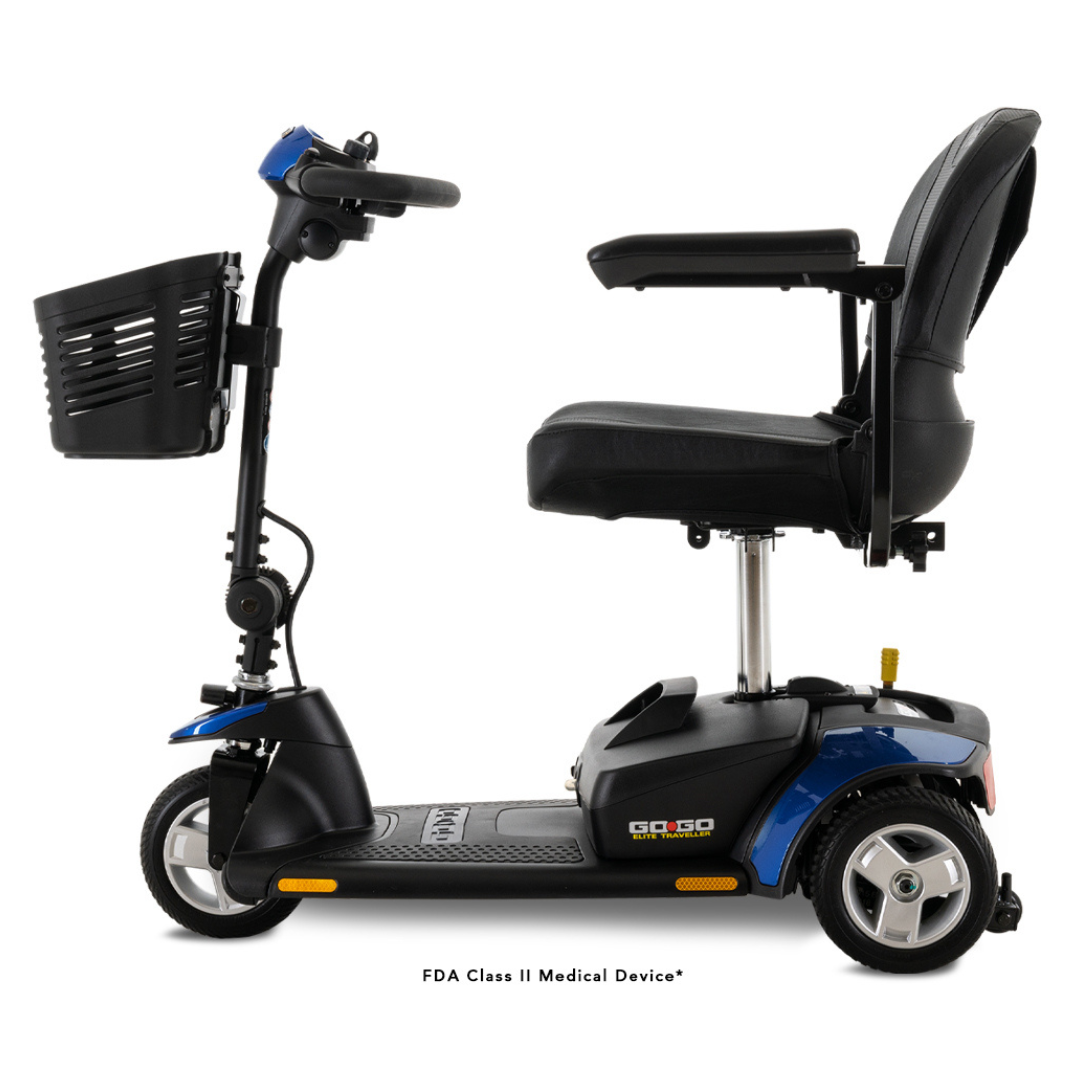 The Pride Mobility Go Go® Elite Traveller 3-Wheel Mobility Scooter features a side view in blue and black with a padded seat, armrests, tiller handlebars, and a front basket. Its lightweight design allows for easy indoor and outdoor maneuverability.