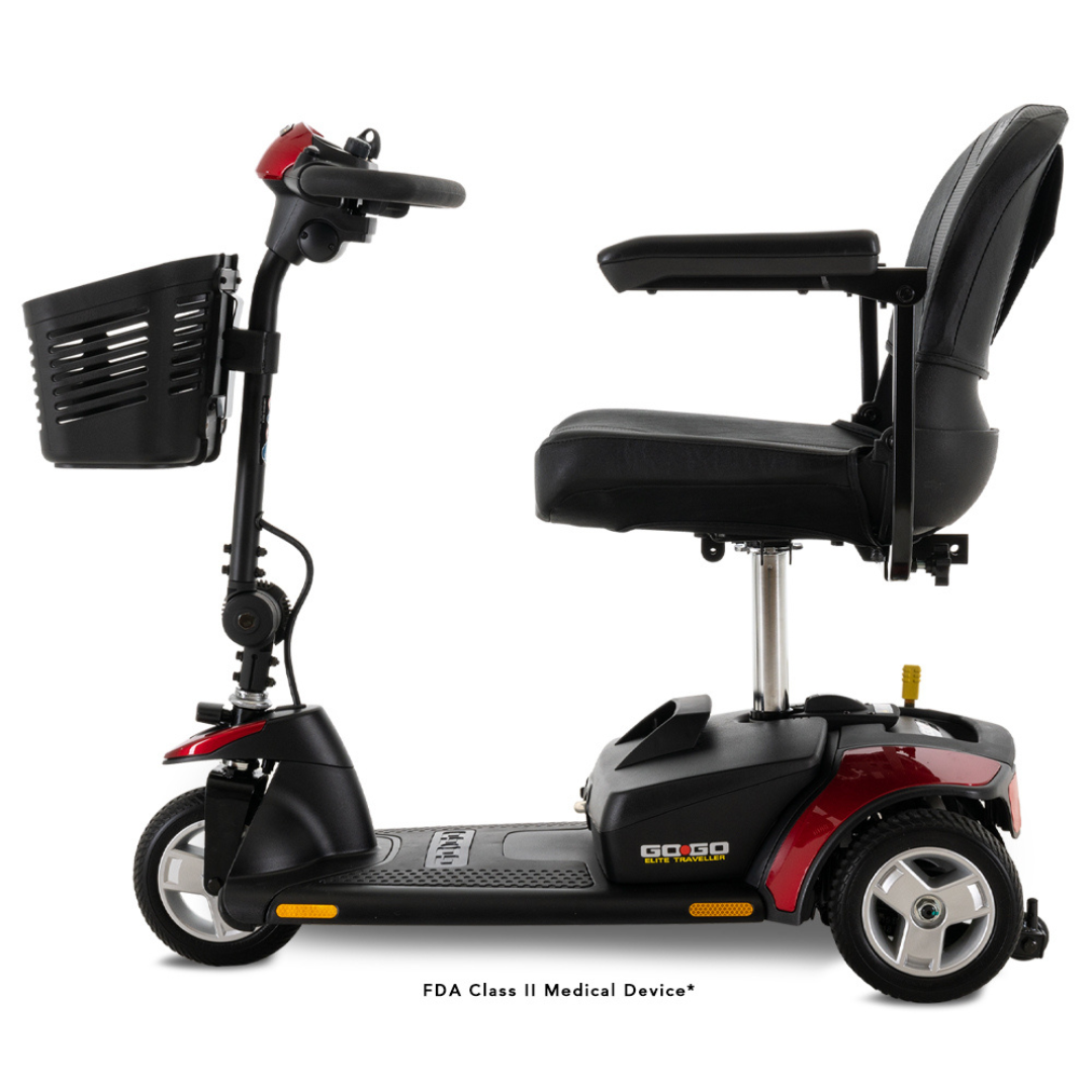 Side view of the Pride Mobility Go Go® Elite Traveller, a customizable red and black 3-wheel mobility scooter with a front basket, padded seat with backrest, and handlebars for steering, set against a white background.