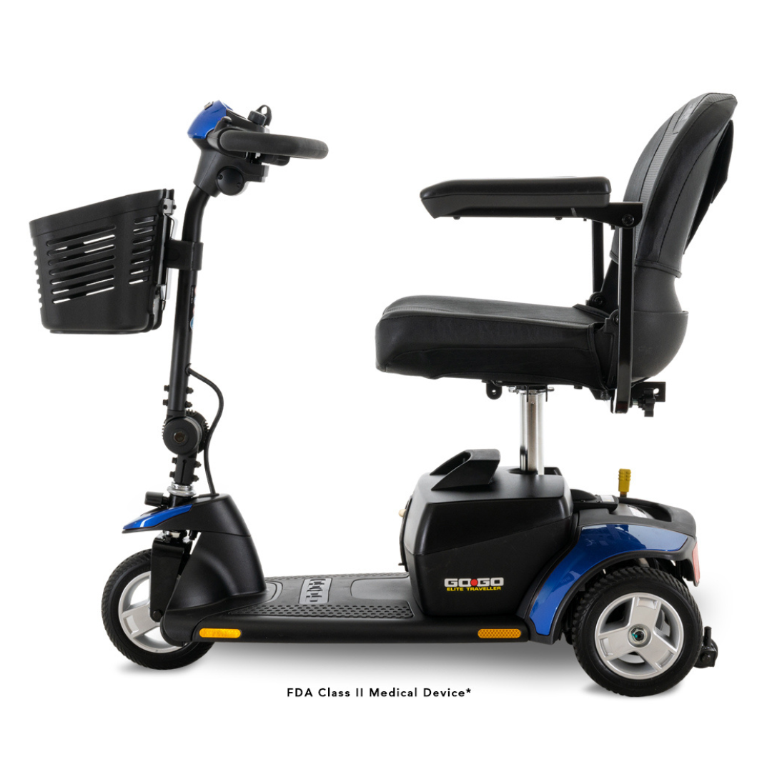 The Pride Mobility Go Go® Elite Traveller 3-Wheel Mobility Scooter features a side view with black and blue colors, a front basket, armrests, and backrest. Its designed as lightweight and travel-friendly with a one-handed frame separation for easy transport.
