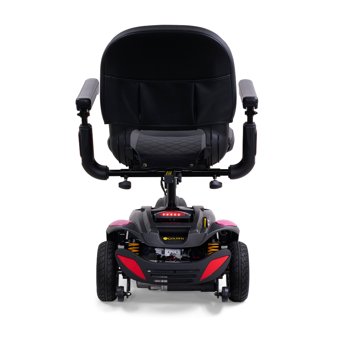 A rear view of a black and red luxury mobility scooter showcases a padded seat with armrests. The Golden Buzzaround LX GB119 - Heavy Duty 3 Wheel Portable Mobility Scooter exhibits its compact design from the back angle.
