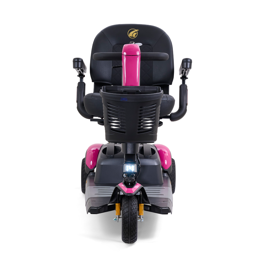 Front view of a Golden Buzzaround LX GB119 - Heavy Duty 3 Wheel Portable Mobility Scooter in pink with black accents, showcasing its cushioned seat, handlebars, and single front wheel. This portable scooter also includes a storage basket located below the handlebars.