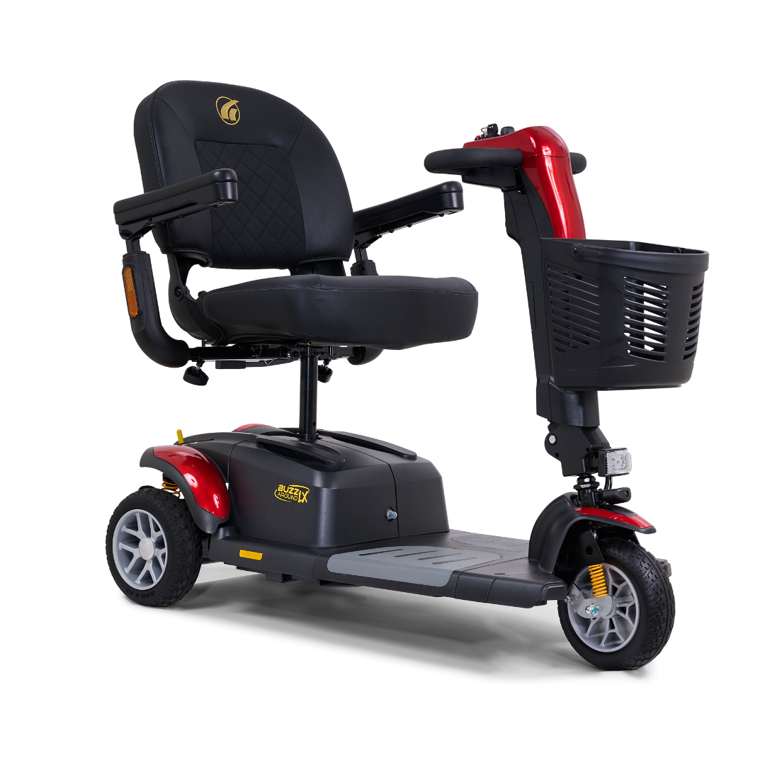 The Golden Buzzaround LX GB119 is a luxurious portable mobility scooter featuring three wheels, a red and black design, a cushioned seat with armrests, and a front-mounted basket.