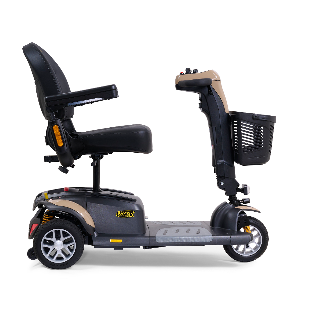 A side view of the Golden Buzzaround LX GB119 - Heavy Duty 3 Wheel Portable Mobility Scooter displays a luxurious design featuring a black seat with armrests, a front basket, and a metallic frame. The scooter includes a central tiller for steering and small, sturdy wheels for enhanced mobility.
