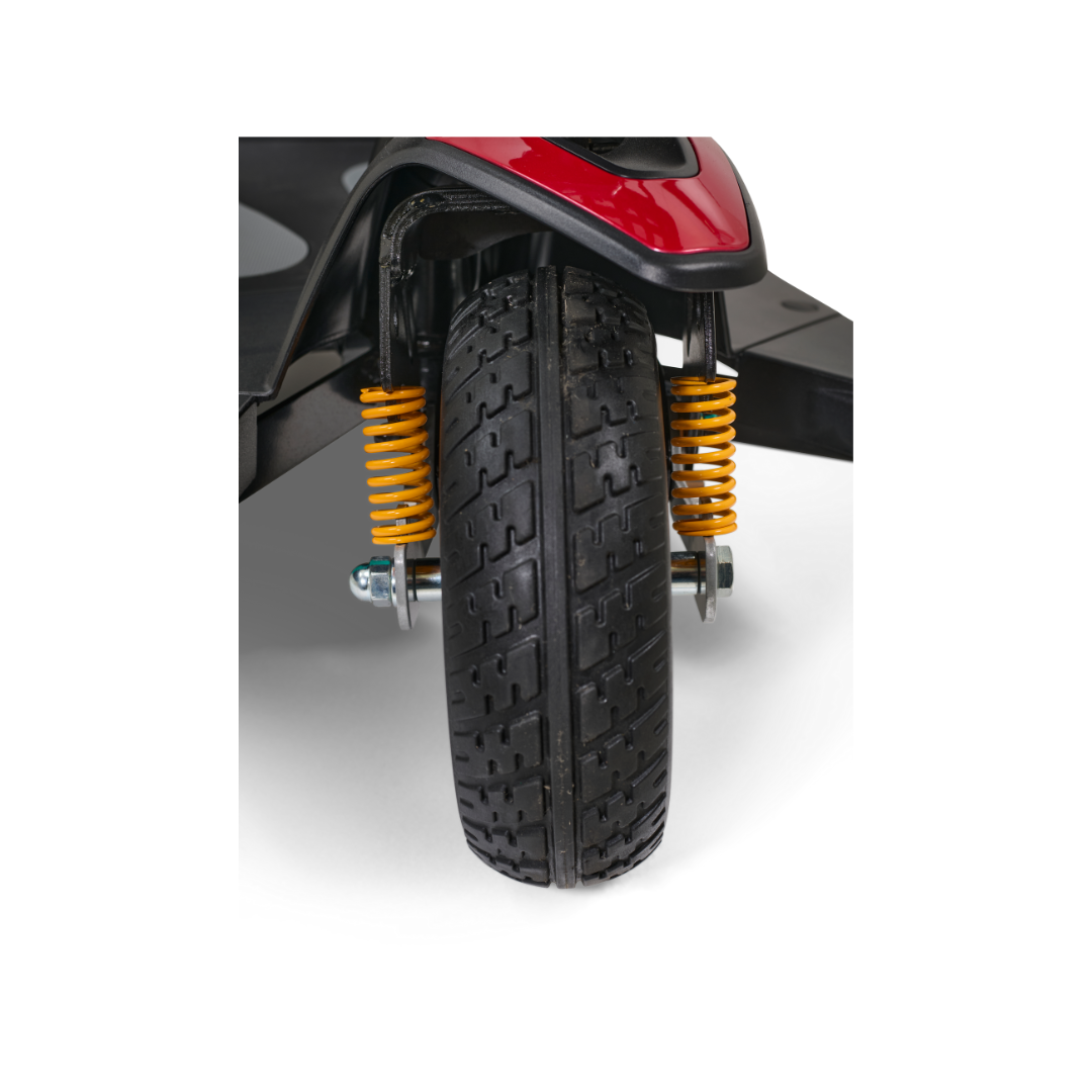 The detailed view of the stylish front wheel highlights the luxurious Golden Buzzaround LX GB119 - Heavy Duty 3 Wheel Portable Mobility Scooter, featuring black treaded tires, vibrant yellow suspension springs, and an eye-catching red fender.