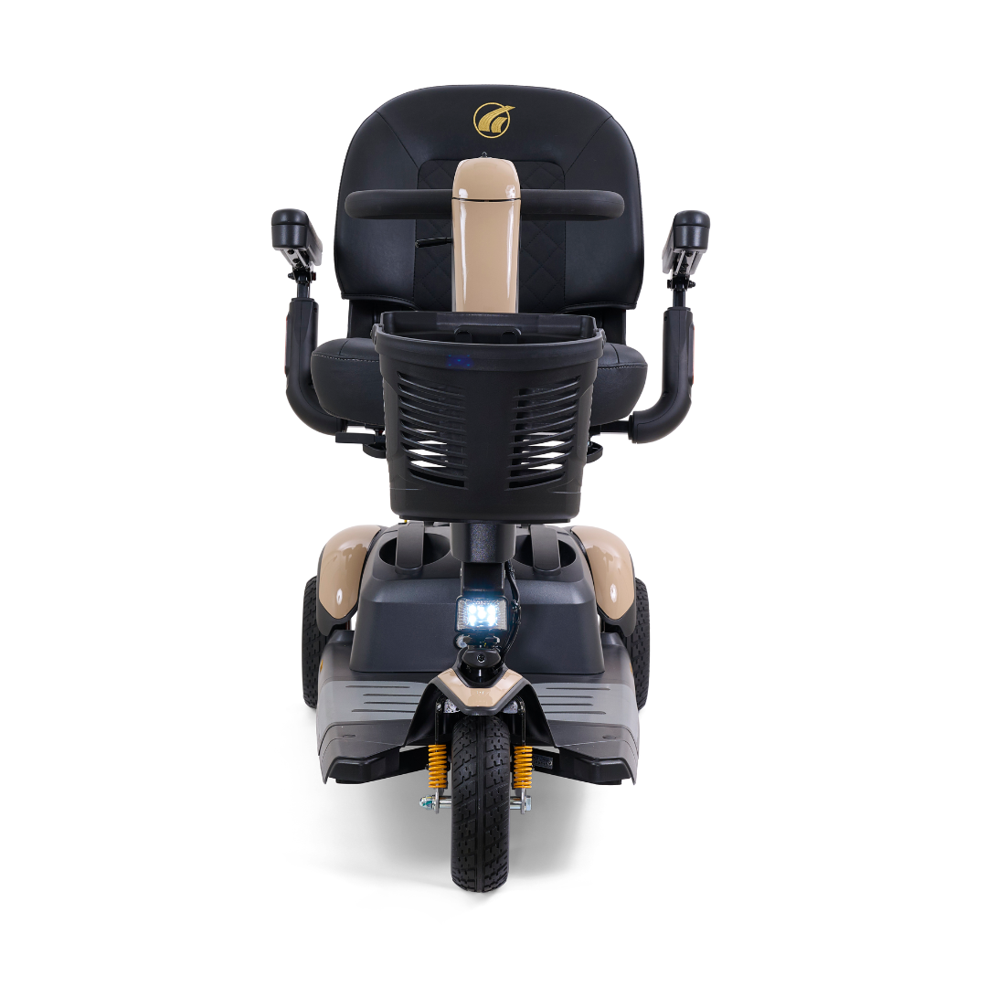The Golden Buzzaround LX GB119 is a high-end mobility scooter in beige, equipped with a black seat and armrests. This portable three-wheel scooter comes with a bottom headlight and includes a handy basket positioned behind the seat.