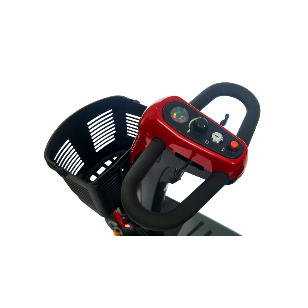 A close-up view of a Golden Buzzaround LX GB119 - Heavy Duty 3 Wheel Portable Mobility Scooter handlebar and control panel reveals its luxurious features, including a speed dial, horn button, and power switch. The scooter is equipped with a black basket at the front, enhancing its stylish red and black color scheme.