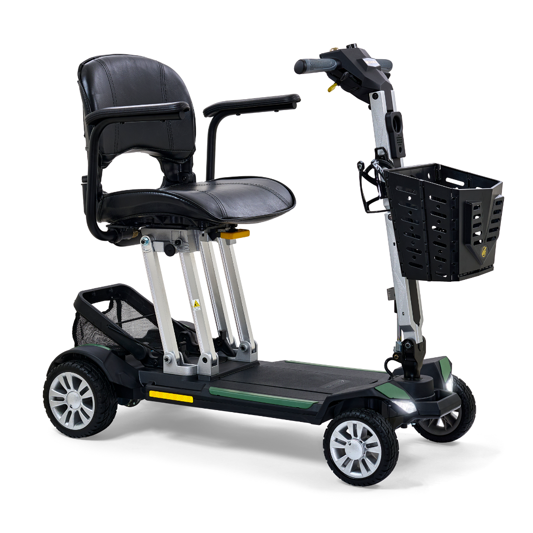 The Golden Technologies Portable Buzzaround GB120 Carry-On Travel Scooter is a black mobility scooter with a fold-flat, four-wheel design. It includes a cushioned seat, armrests, adjustable handlebars, and a small front basket. This ultra-portable scooter is equipped with a lithium-ion battery, making it perfect for personal transportation and accessibility needs.