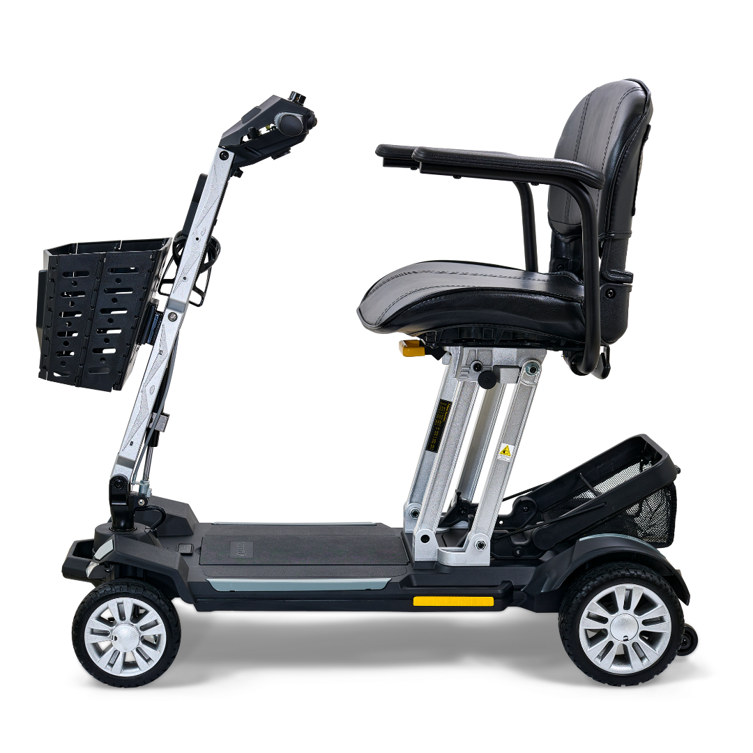 Introducing the Golden Technologies Portable Buzzaround GB120 Carry-On Travel Scooter: a sleek black and silver mobility scooter equipped with a cushioned seat, armrests, and a front basket. It features an ultra-portable design with four wheels for easy transport, as well as a compact fold-flat capability ideal for storage and travel.