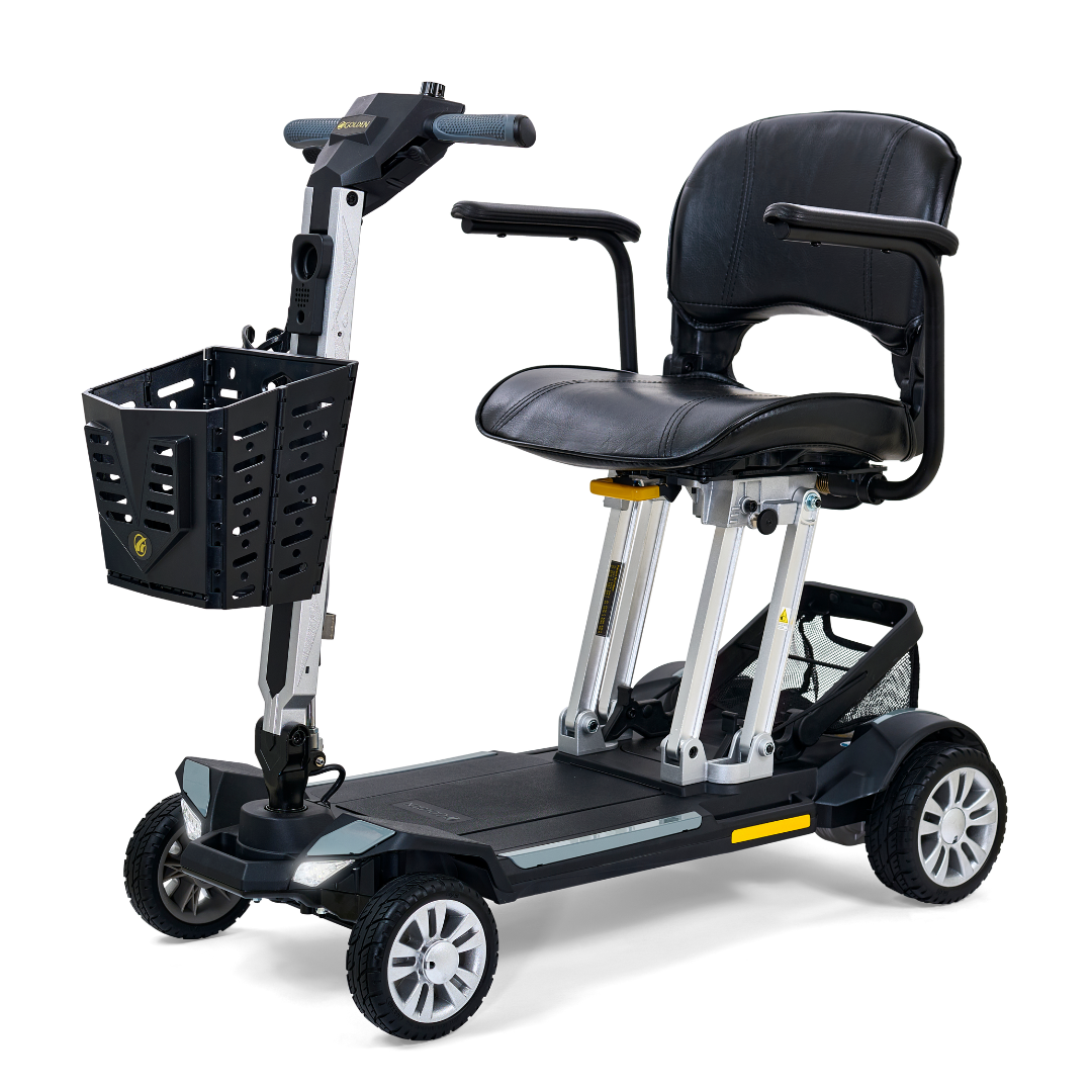 Introducing the Golden Technologies Portable Buzzaround GB120 Carry-On Travel Scooter, an ultra-portable mobility solution boasting a sleek black design. It features a cushioned seat with armrests and comes equipped with a convenient front basket. Its innovative fold-flat capability allows for effortless storage, while the lightweight frame and stable four-wheel base are powered by an advanced lithium-ion battery for smooth and reliable performance.