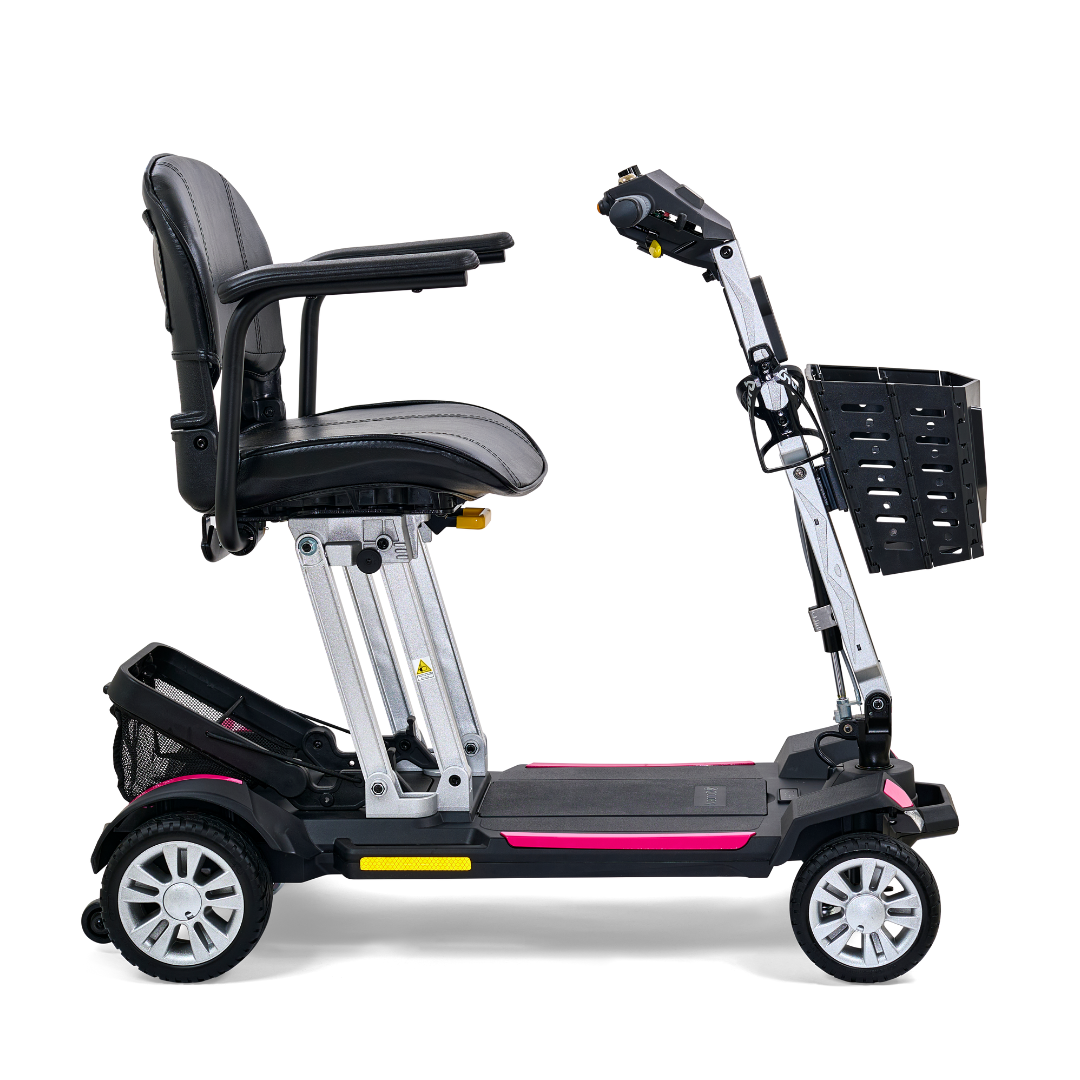 The Golden Technologies Portable Buzzaround GB120 Carry-On Travel Scooter is an ultra-portable, fold-flat mobility solution featuring a padded seat and armrests, four wheels, and a handy black basket at the front. Its predominantly black frame highlighted with pink accents is powered by a robust lithium-ion battery, offering extended mobility.