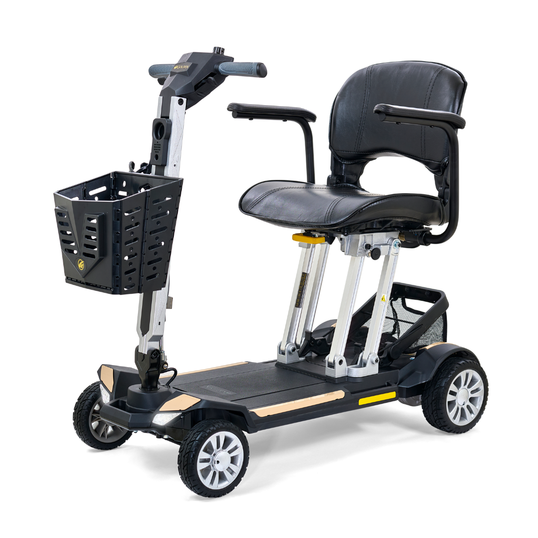 The Golden Technologies Portable Buzzaround GB120 Carry-On Travel Scooter is a black electric mobility scooter that boasts a sturdy seat, armrests, and a front basket. Its sleek, fold-flat design makes it ultra-portable, and it features four wheels along with a lithium-ion battery for ideal personal transportation.