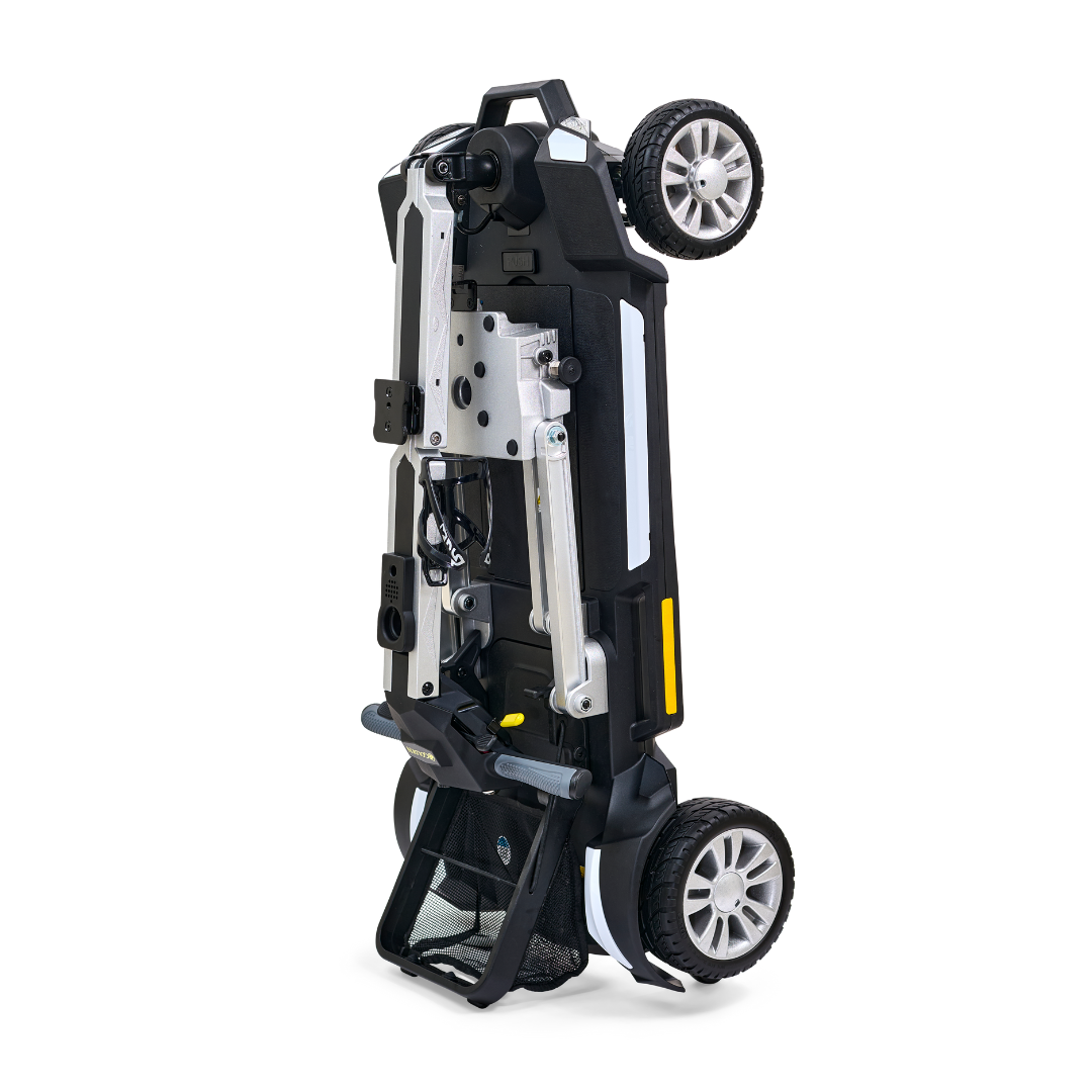 Introducing the Golden Technologies Portable Buzzaround GB120 Carry-On Travel Scooter: a fold-flat model in sophisticated black and silver, designed for ultra-portability with its four-wheel construction. This scooter is displayed in an upright position and comes equipped with a powerful lithium-ion battery to ensure extended travel capabilities.