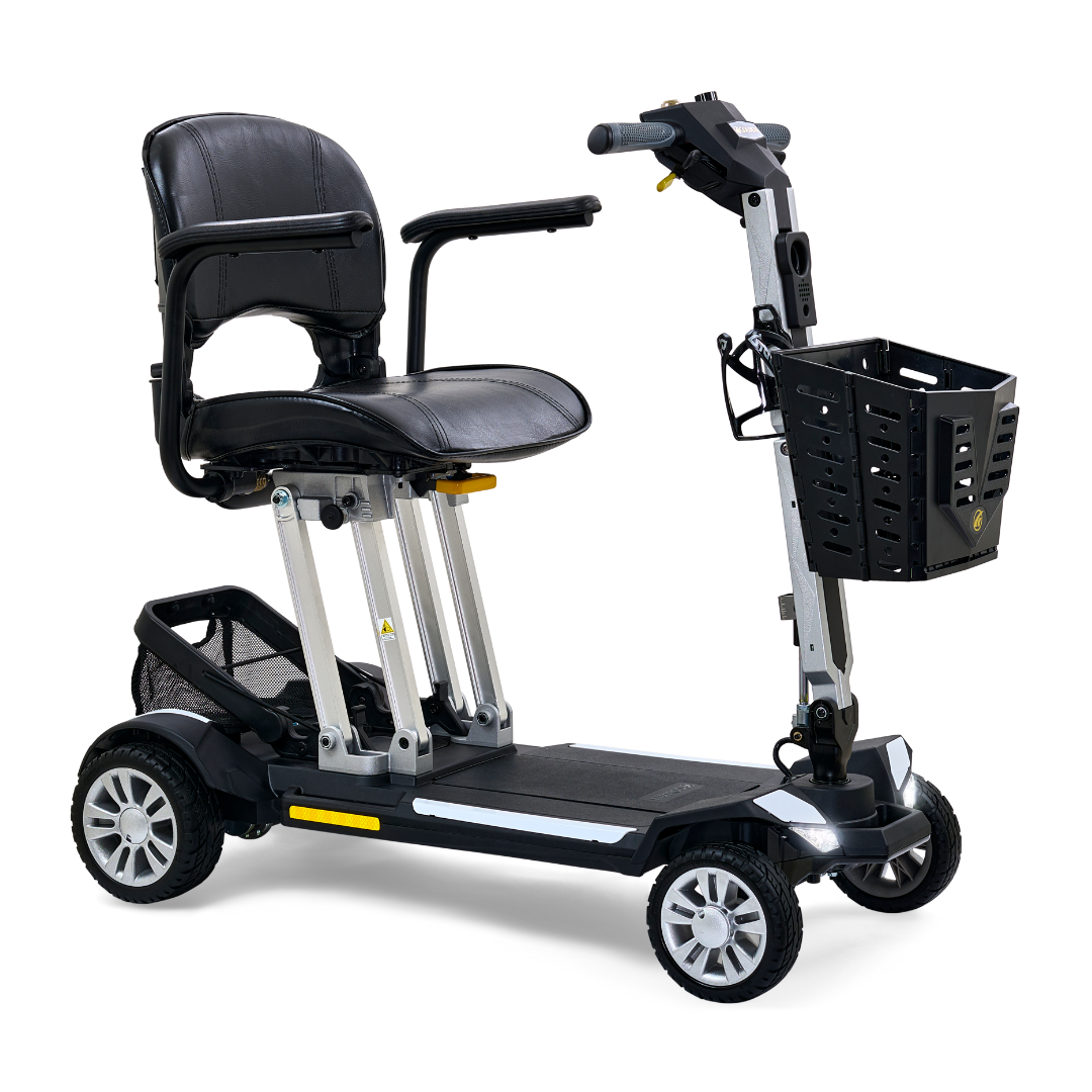 The Golden Technologies Portable Buzzaround GB120 Carry-On Travel Scooter is a compact, four-wheeled mobility device featuring a comfortable black seat and backrest, handlebars, a convenient front basket, and supportive armrests. Its ultra-portable design includes robust wheels for easy maneuverability and features a fold-flat mechanism powered by a lithium-ion battery to enhance user comfort.