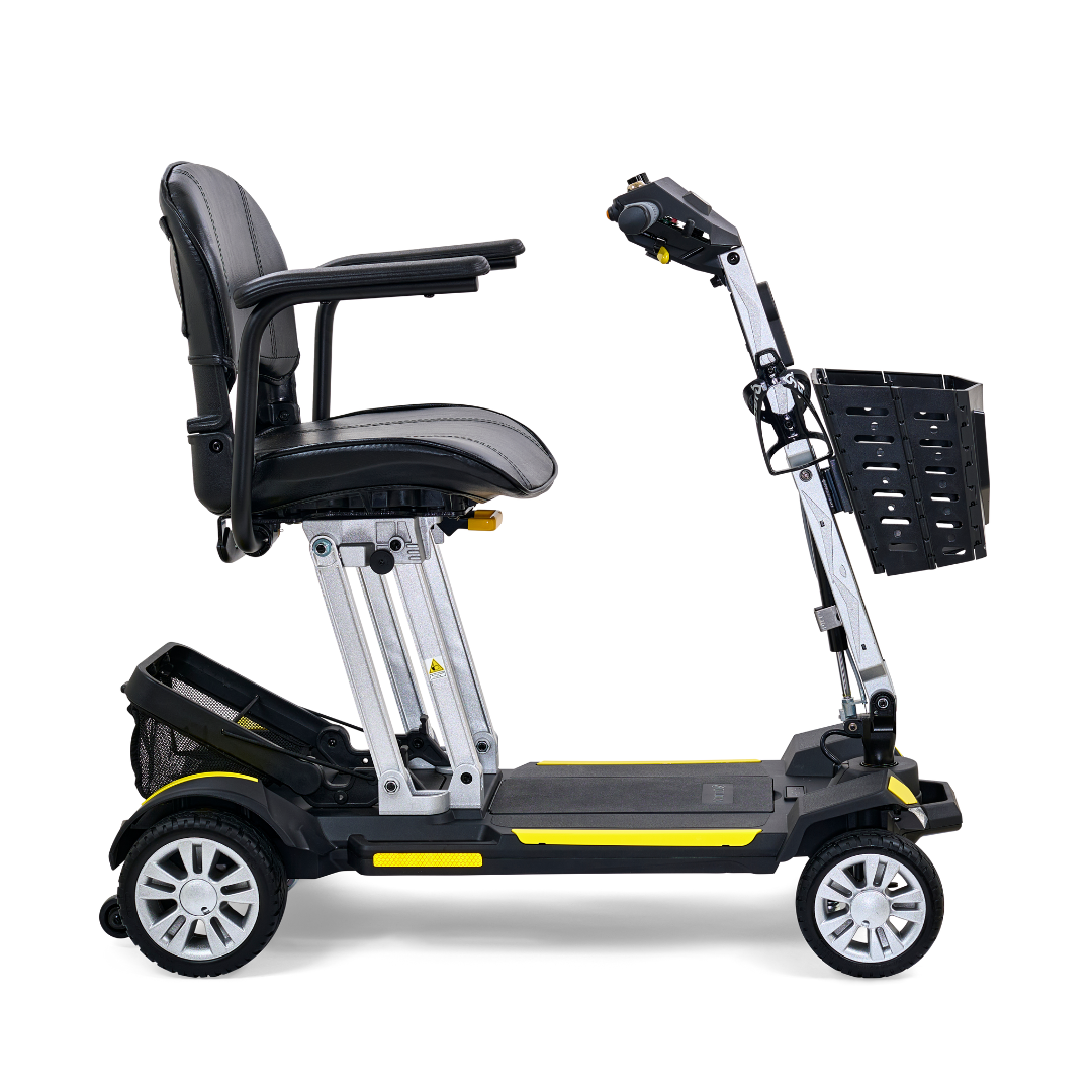 Introducing the Golden Technologies Portable Buzzaround GB120 Carry-On Travel Scooter, a sleek black and yellow mobility solution. It boasts a cushioned seat and a convenient basket attached to the front handlebar. Designed for stability with four wheels, this scooter features a foldable design for easy transport and is powered by a lithium-ion battery for extended use.