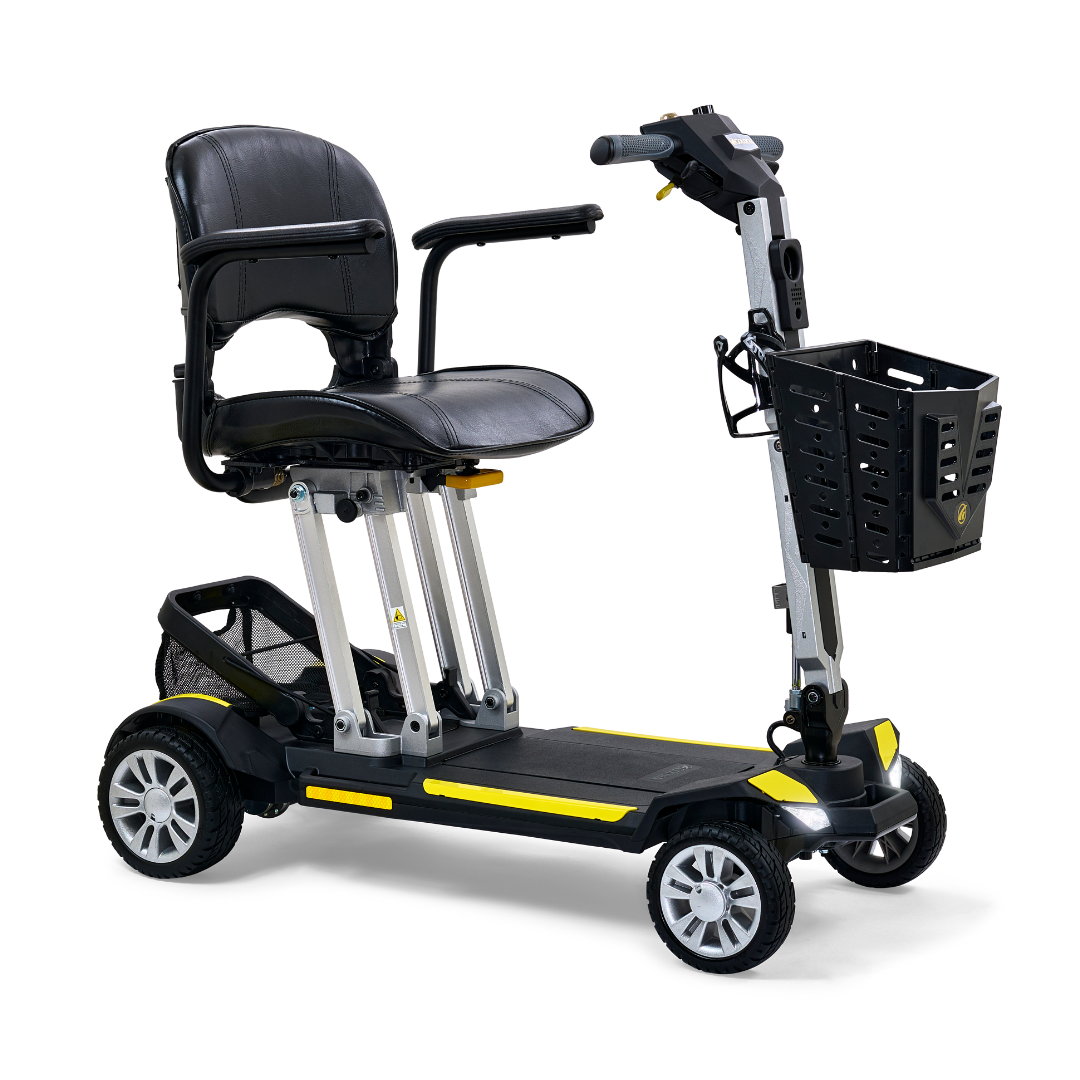 Introducing the Golden Technologies Portable Buzzaround GB120 Carry-On Travel Scooter, a sleek black and yellow fold-flat scooter with four wheels. It includes a padded seat complete with armrests, a small basket attached to the handlebar for added convenience, an adjustable backrest and footplate, all powered by an efficient lithium-ion battery for smooth personal transportation.