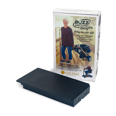 A rectangular black Golden Technologies GB120 & GB220 Scooter Battery with Carry Case sits in front of a product box showing a smiling woman beside a folded, airline-compliant Buzzaround Carry On mobility scooter.