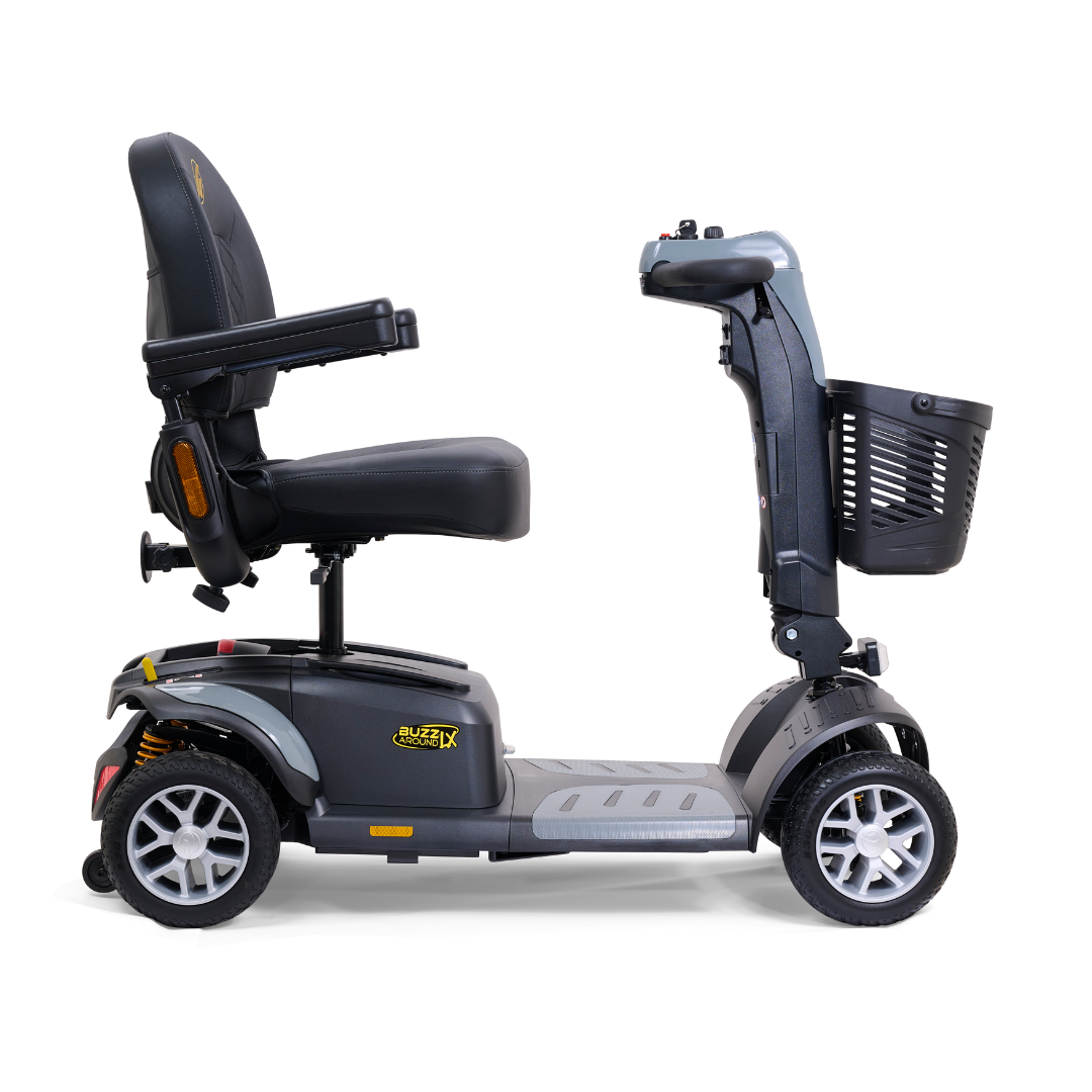 The Golden Buzzaround LX GB149 is a stylish black and gray mobility scooter that offers a side view of its heavy-duty four-wheel design. It features an adjustable tiller, cushioned seat, handlebars, and a front basket. This portable travel scooter is perfect for providing convenience and comfort on the go.