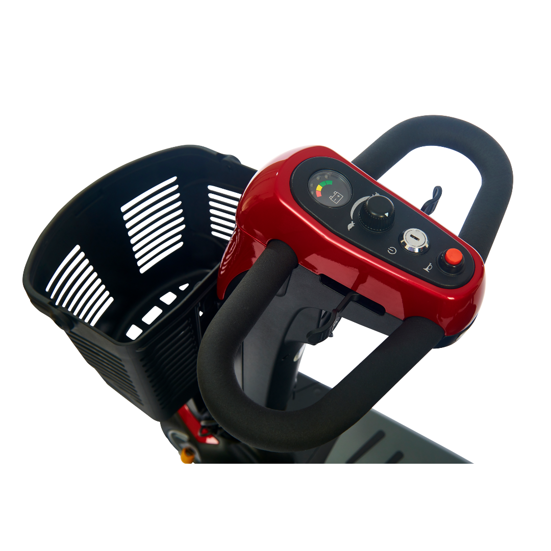 Close-up view of the Golden Buzzaround LX GB149's handlebars and control panel, showcasing a red control unit with a dial and button, an adjustable tiller, and a black basket attachment at the front.
