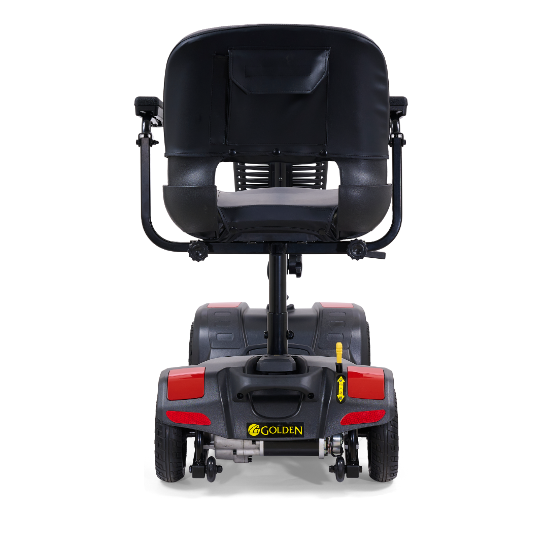 Rear view of the Golden Tech GB108 Buzzaround LT 4-Wheel Mobility Scooter in black, showing a lightweight stadium-style seat with cushion, backrest pocket, armrests, four wheels, red reflectors; supports up to 300 lb.